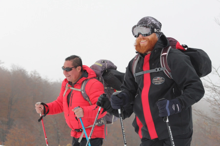 “Excursionistas avanzando con raquetas en el Trekking con Raquetas a la Base del Volcán Villarrica.”